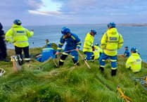 Emergency services rescue injured woman near cliff edge