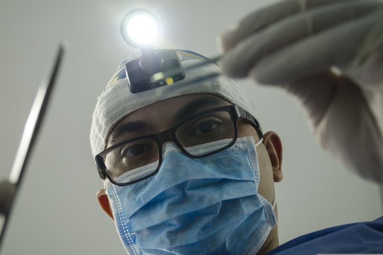 Dentist with head torch