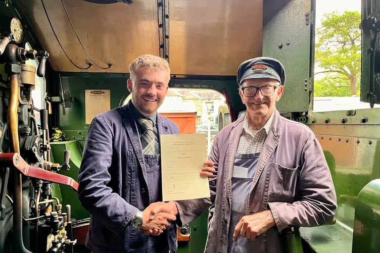 Will Dingle being presented with his driver’s certificate by traction inspector Courtney Berryman, from St Austell, on the footplate of a locomotive. (Picture: Chris Hatton)