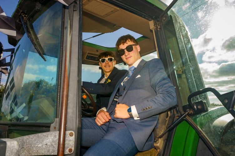 Students arrive in the obligatory tractor