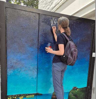 Diane Griffiths repairing her artwork