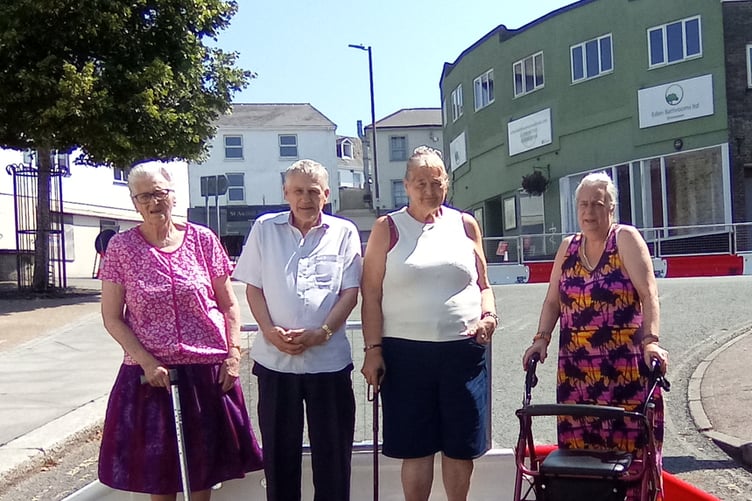 Trustees and clients at the community centre want the barrier at the top of West Hill removed.