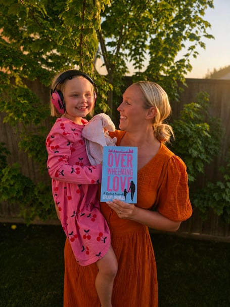 Leanne with her daughter and her debut novel Overwhelming Love
