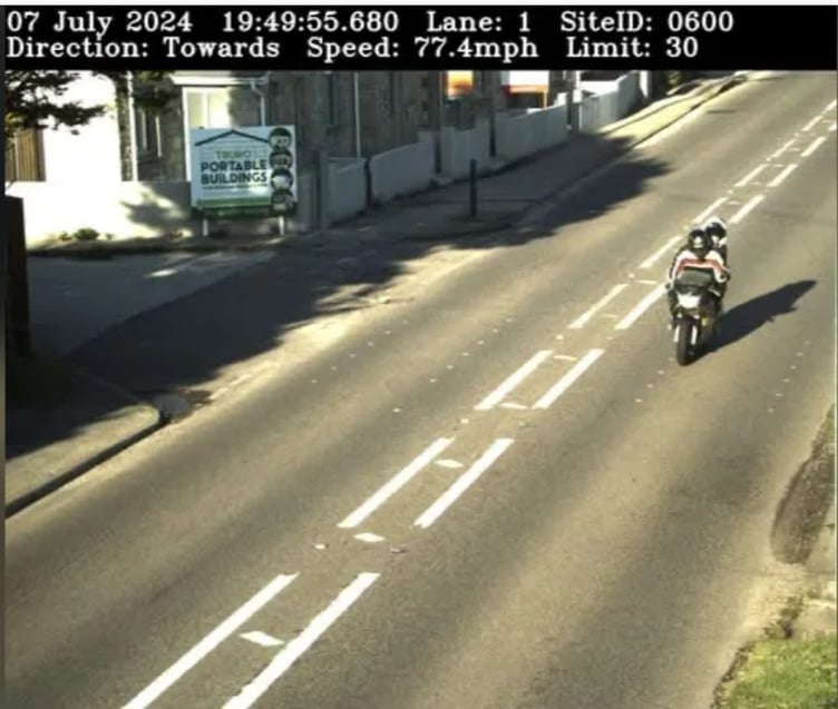 The rider was caught doing 77mph in a 30mph zone - with a passenger on board