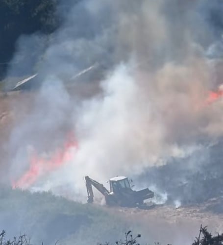 Danny Wadman jumped into his digger to carve out a firebreak trench