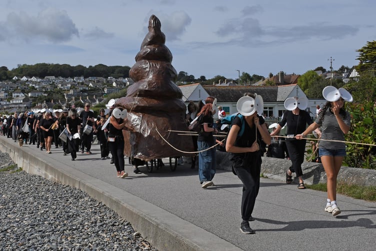 Campaigners dressed as flies to drag a huge poo emoji to the site of the development (Picture: Howard Phillips)