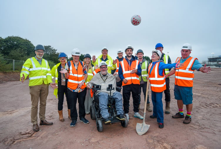Construction workers and councillors celebrate work starting on the 3G pitch at Langarth, near Truro