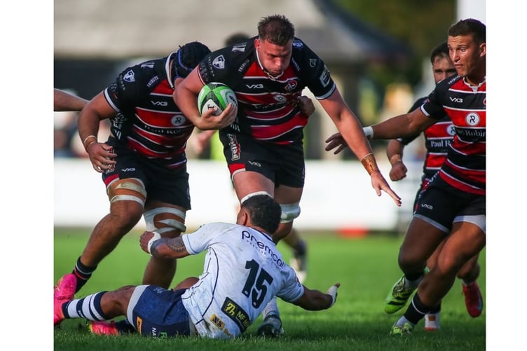 Man-of-the-match Hugh Bokenham powers forward.