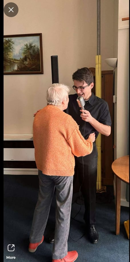 Jacob singing to one of the elderly residents