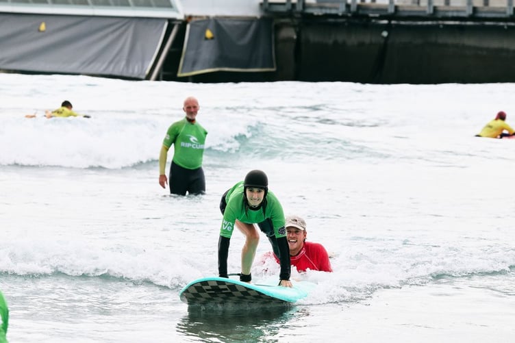 Stephen Downes watches on as a participant takes off on a wave