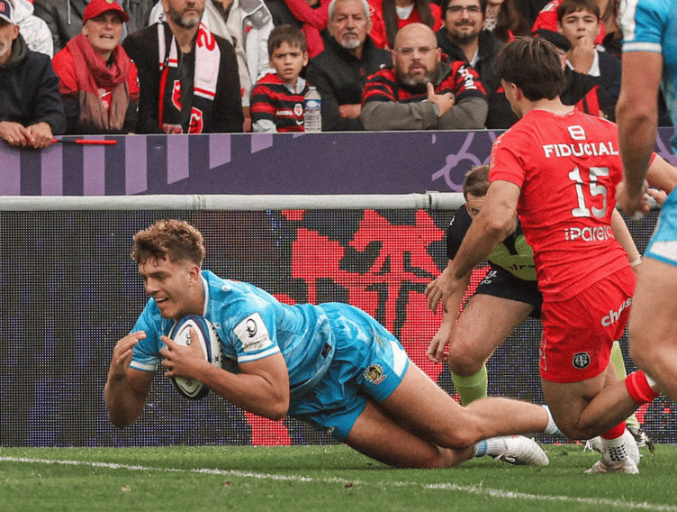 Exeter Chiefs winger Zack Wimbush crosses for one of his three tries in his side's Champions Cup encounter with Toulouse
