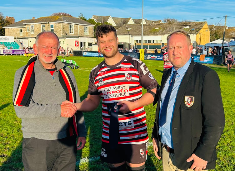 Nick Nowell was presented a merit tie for reaching 100 appearances for the Pirates by club president Phil Westren (left) and club official Jack Nicholas.