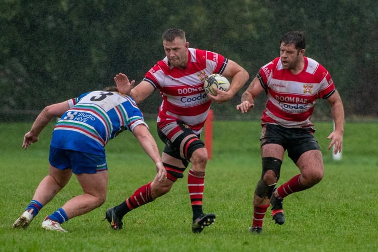 Lock Adam Powell drives forward as hat-trick hero Charlie Nicholson watches on.